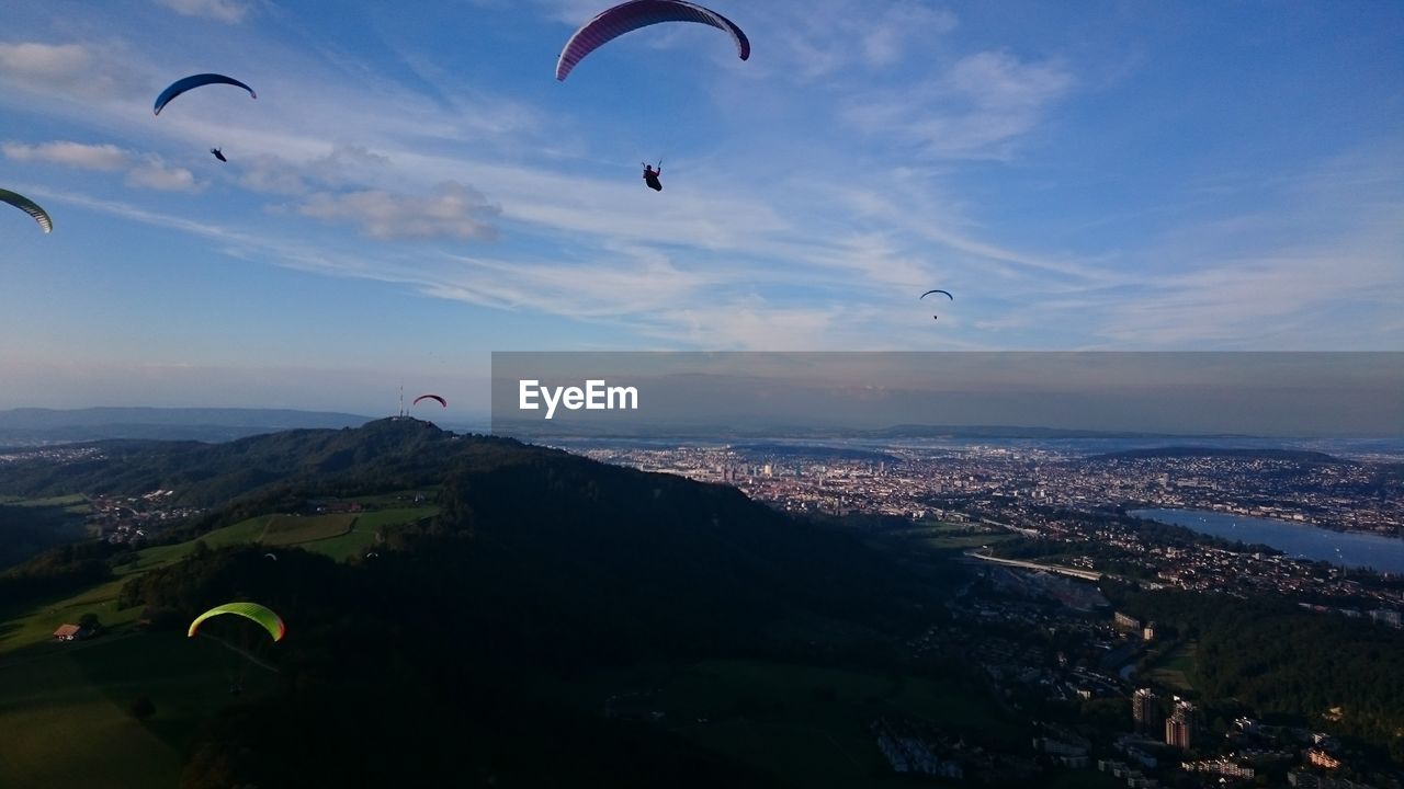 Aerial view of mountain and cityscape against sky