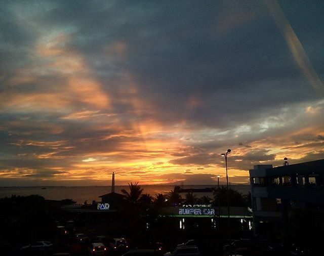 SILHOUETTE OF CITY AGAINST DRAMATIC SKY DURING SUNSET