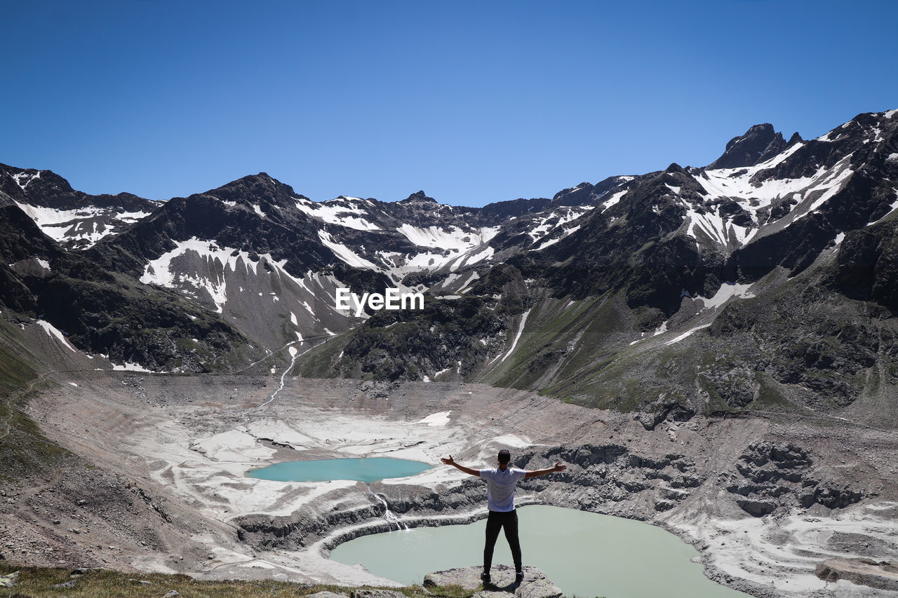 Dream come true for a boy with an athletic figure standing over the drained finstertal dam 