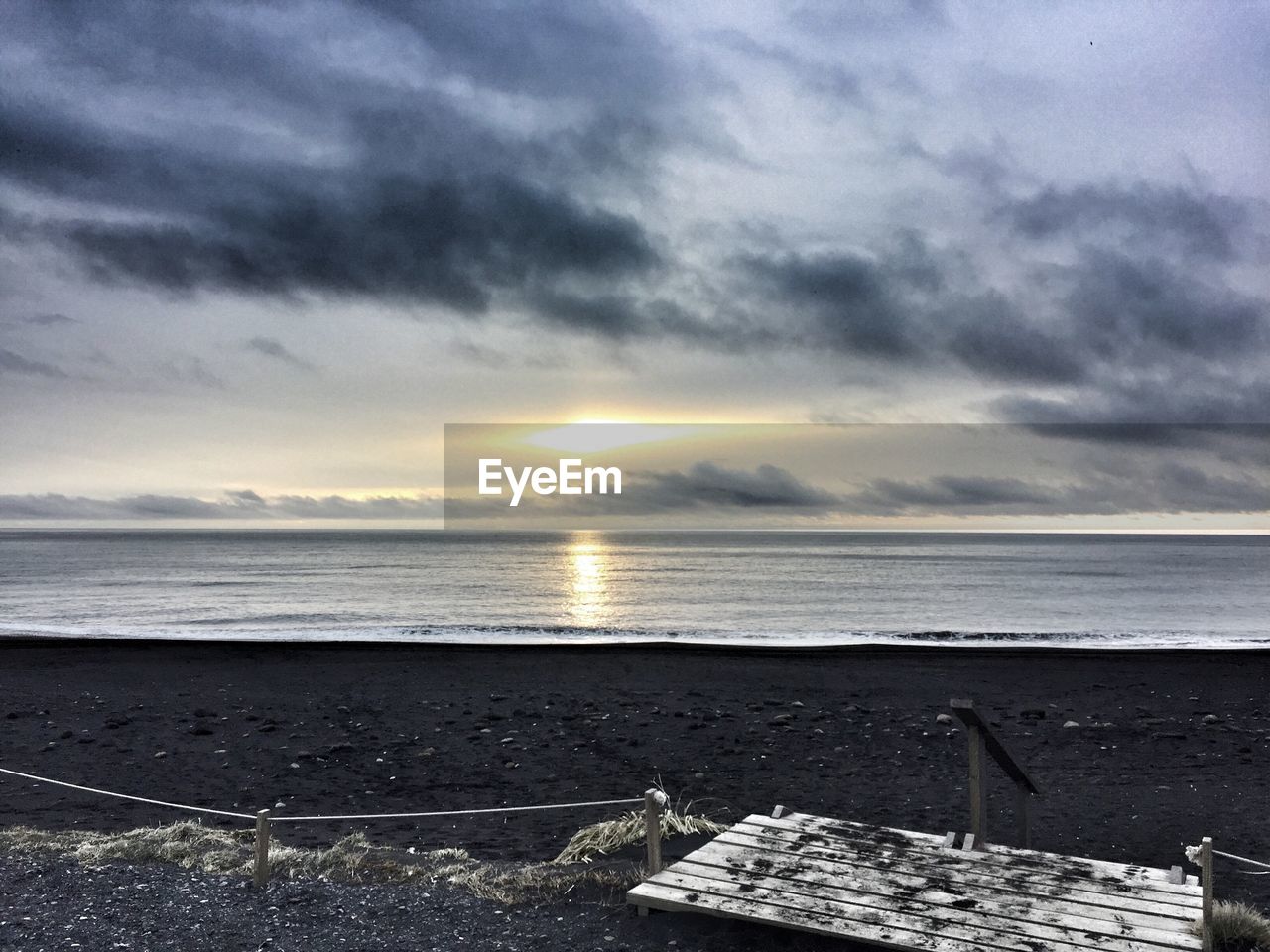 SCENIC VIEW OF BEACH AGAINST SKY DURING SUNSET