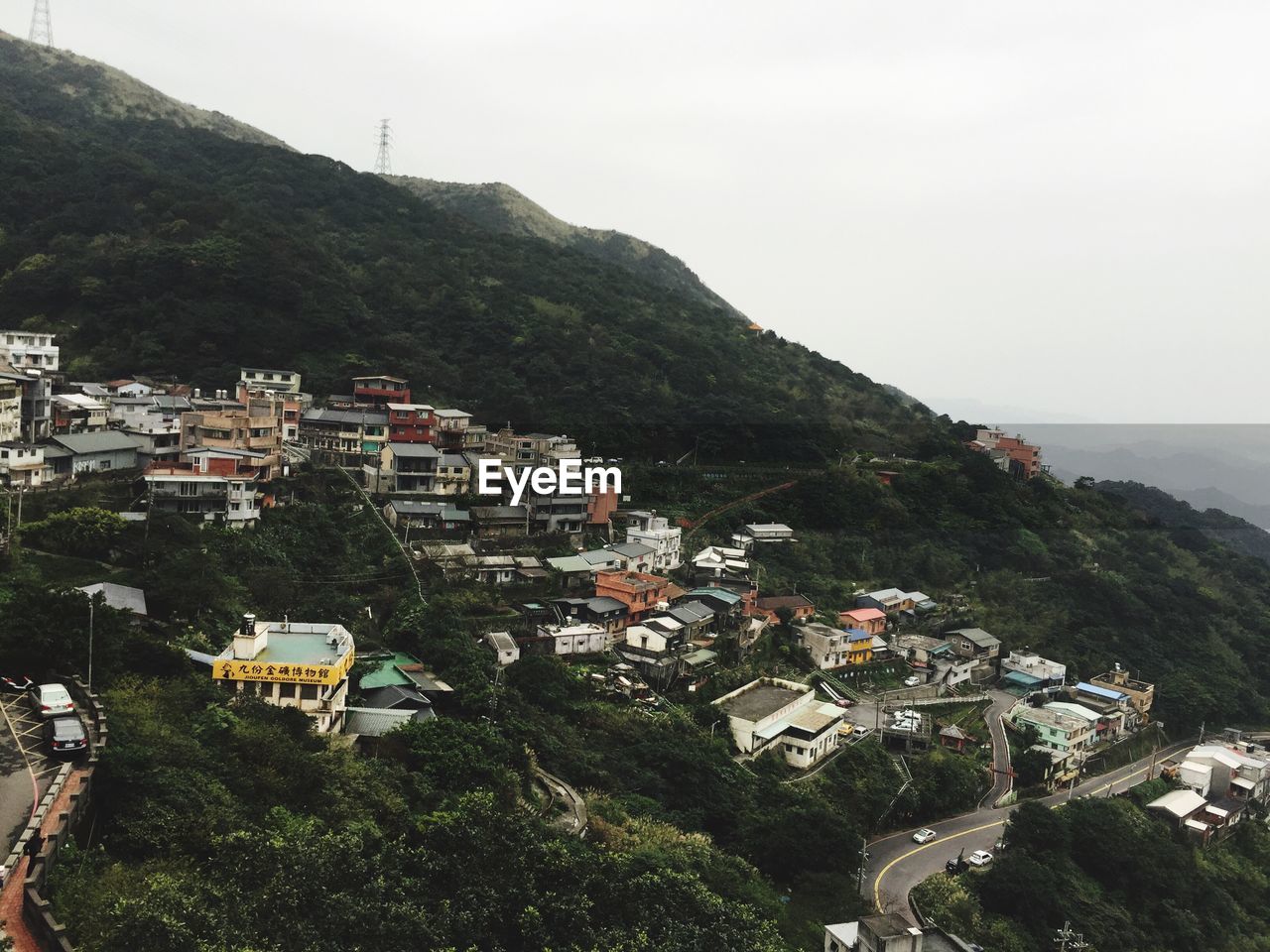 Houses on mountain against sky