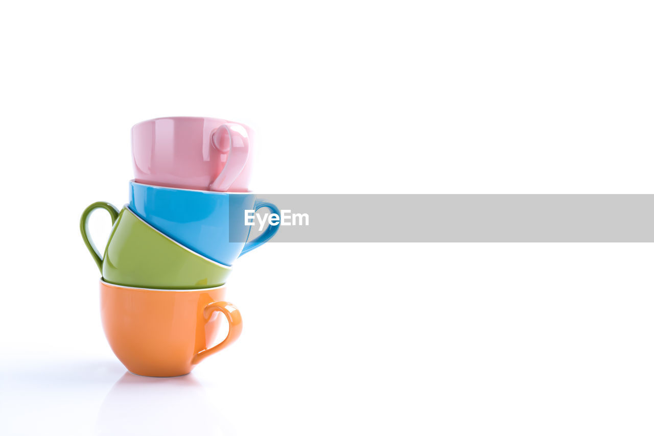 Stacked ceramic cup with copy space on isolated white
