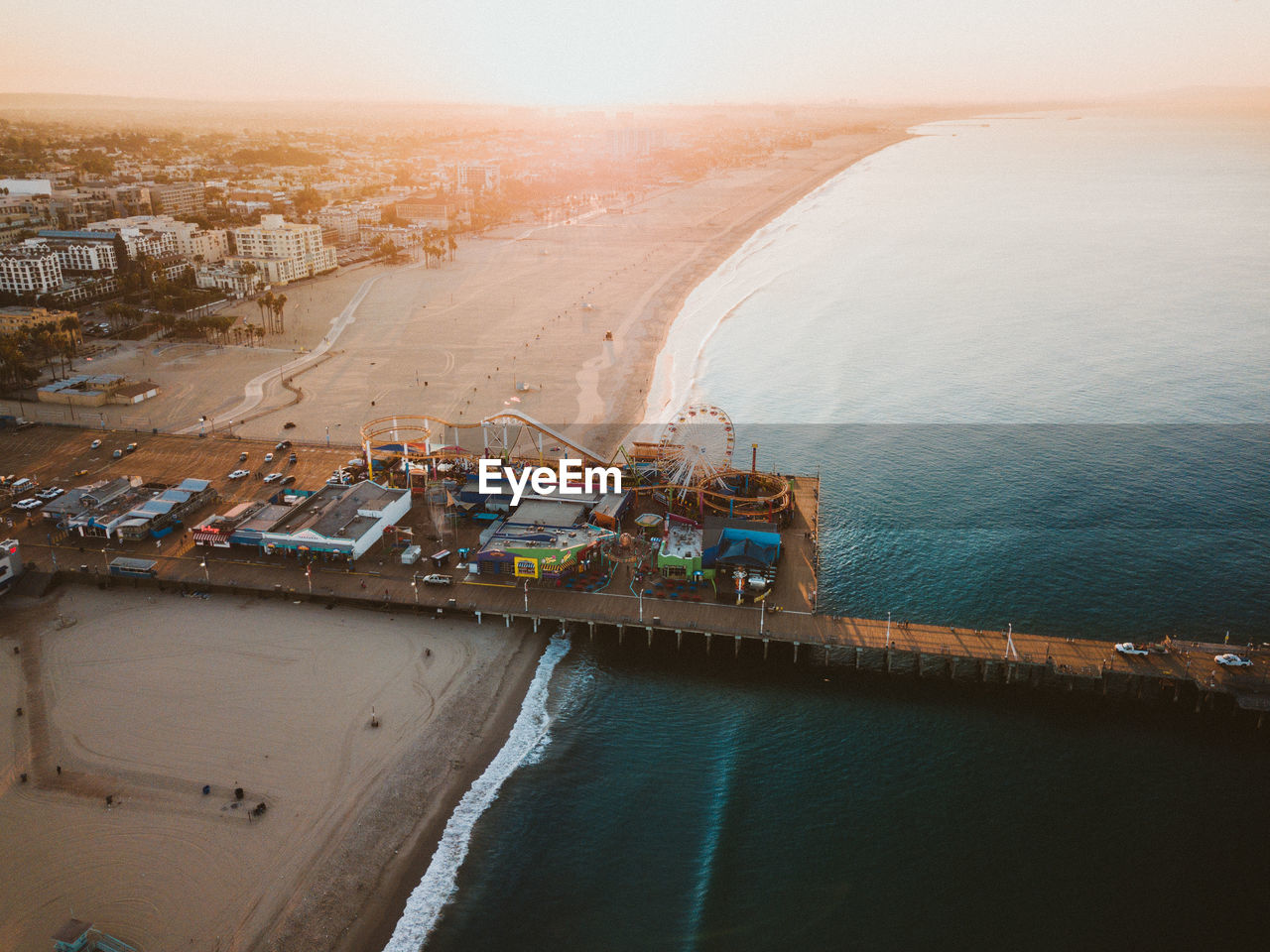 Aerial view of amusement park at beach during sunset