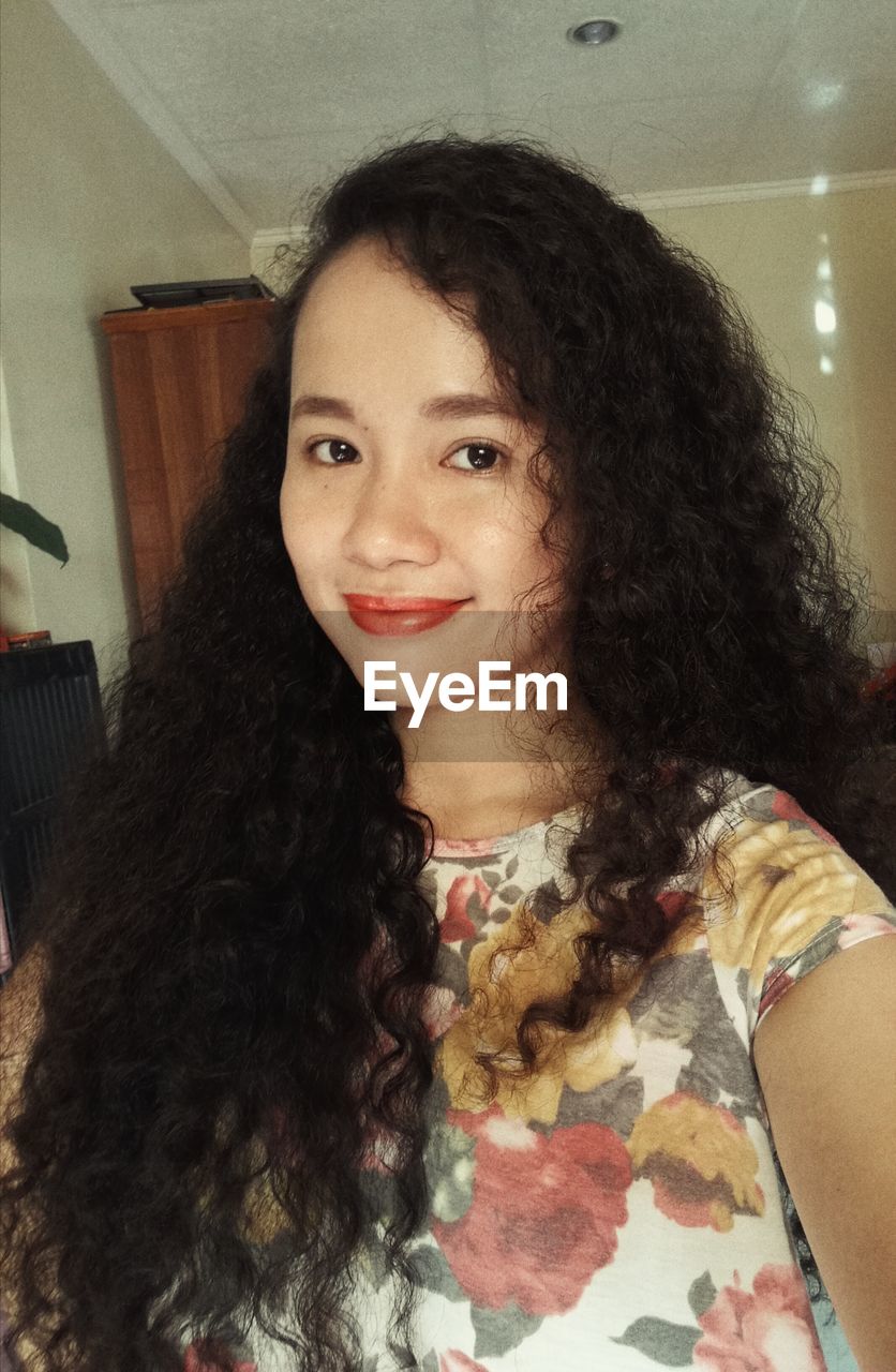 Portrait of smiling young woman at home