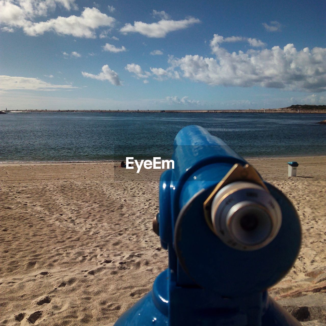CLOSE-UP OF COIN-OPERATED BINOCULARS ON BEACH