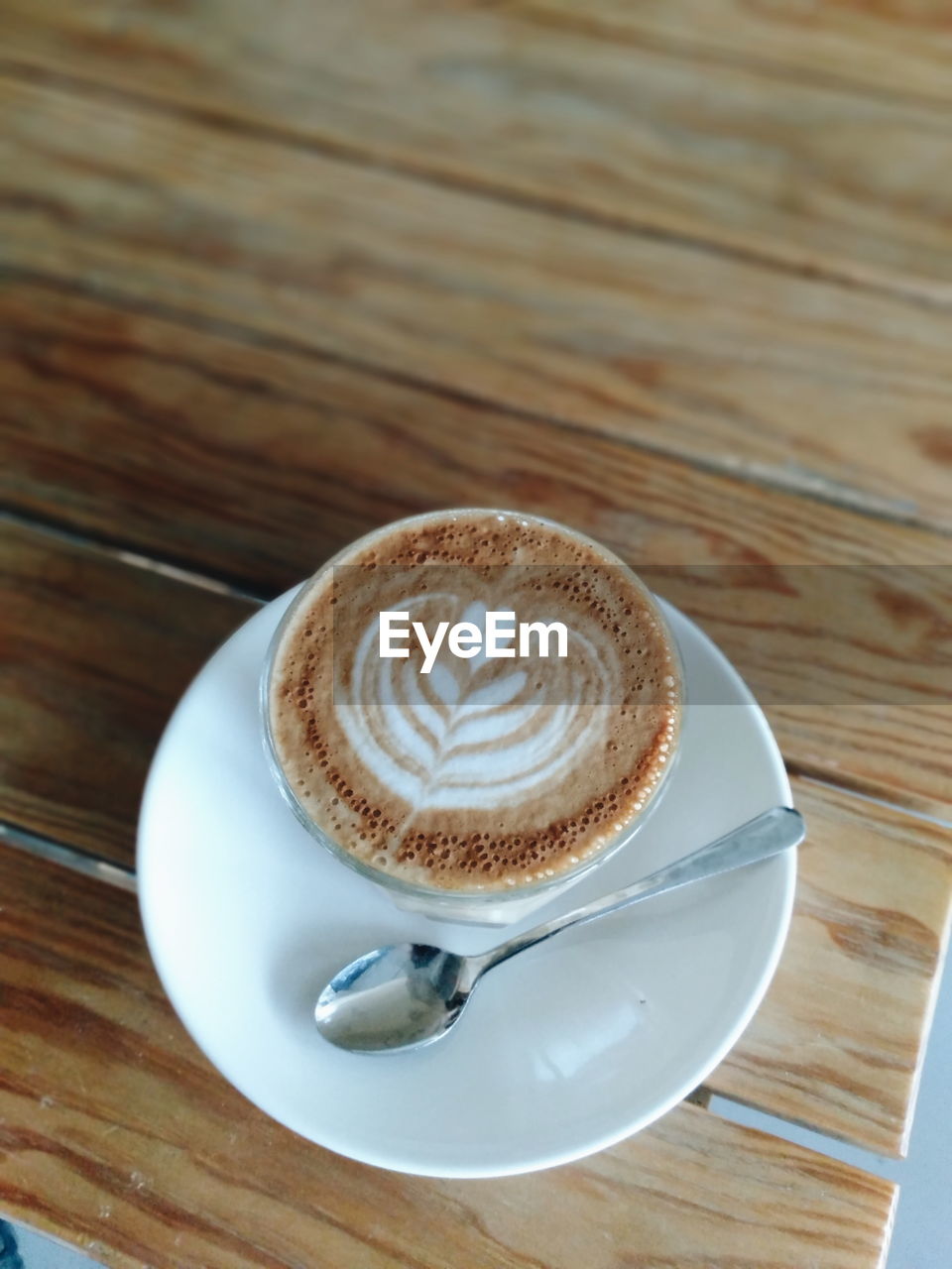 CUP OF COFFEE ON TABLE WITH SPOON