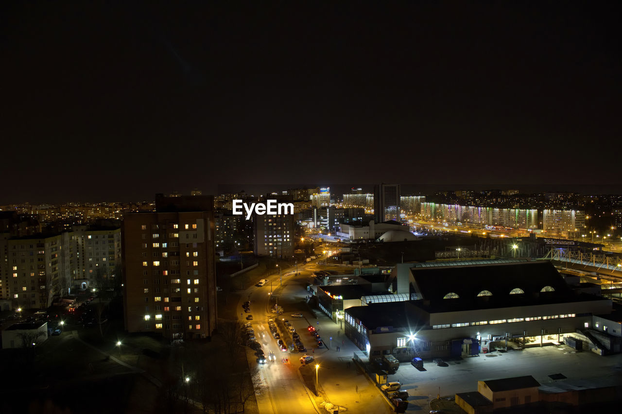 High angle view of illuminated cityscape against sky at night