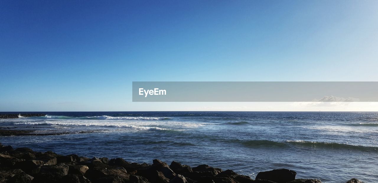 SCENIC VIEW OF BEACH AGAINST CLEAR SKY