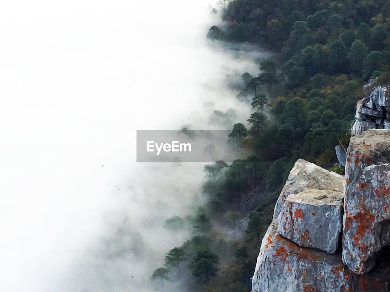 Scenic view of mountain range against cloudy sky