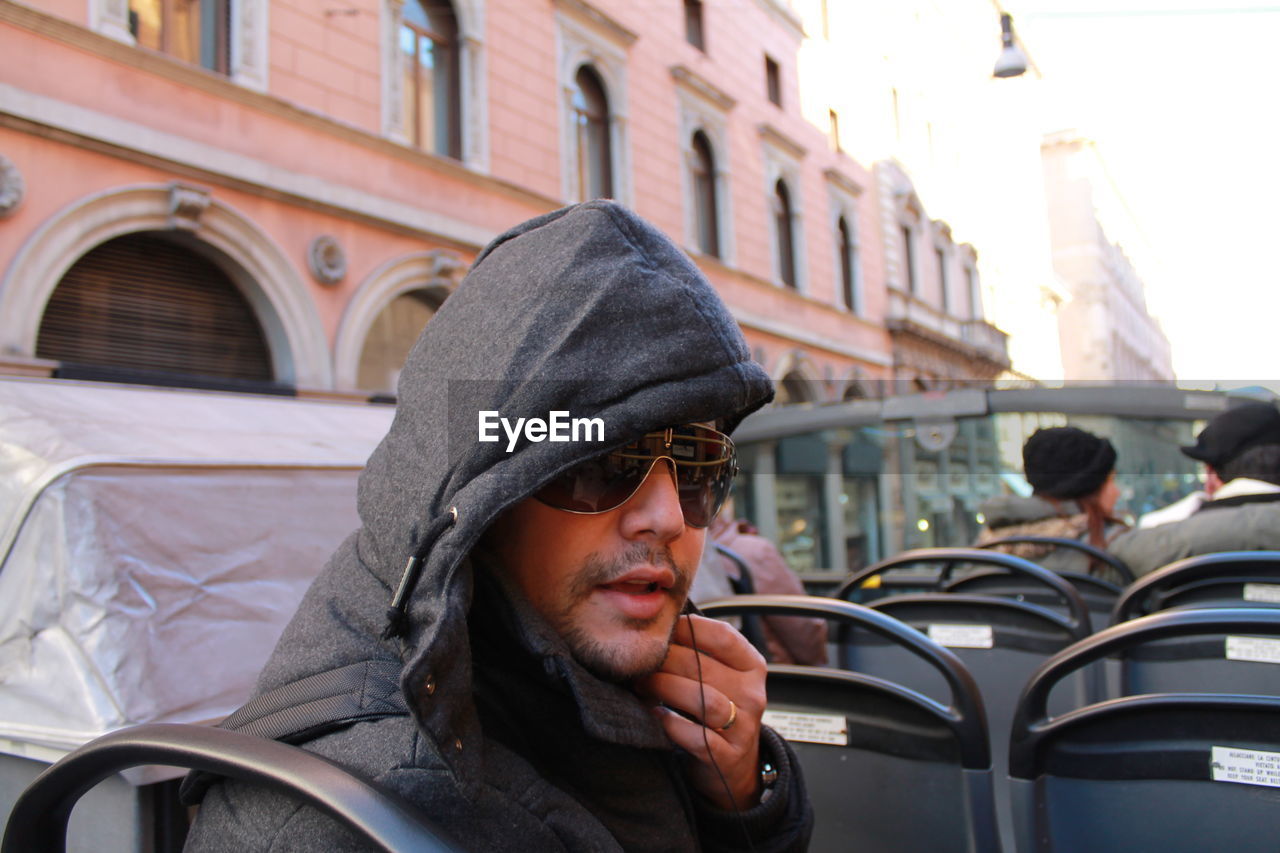 Portrait of young man in bus