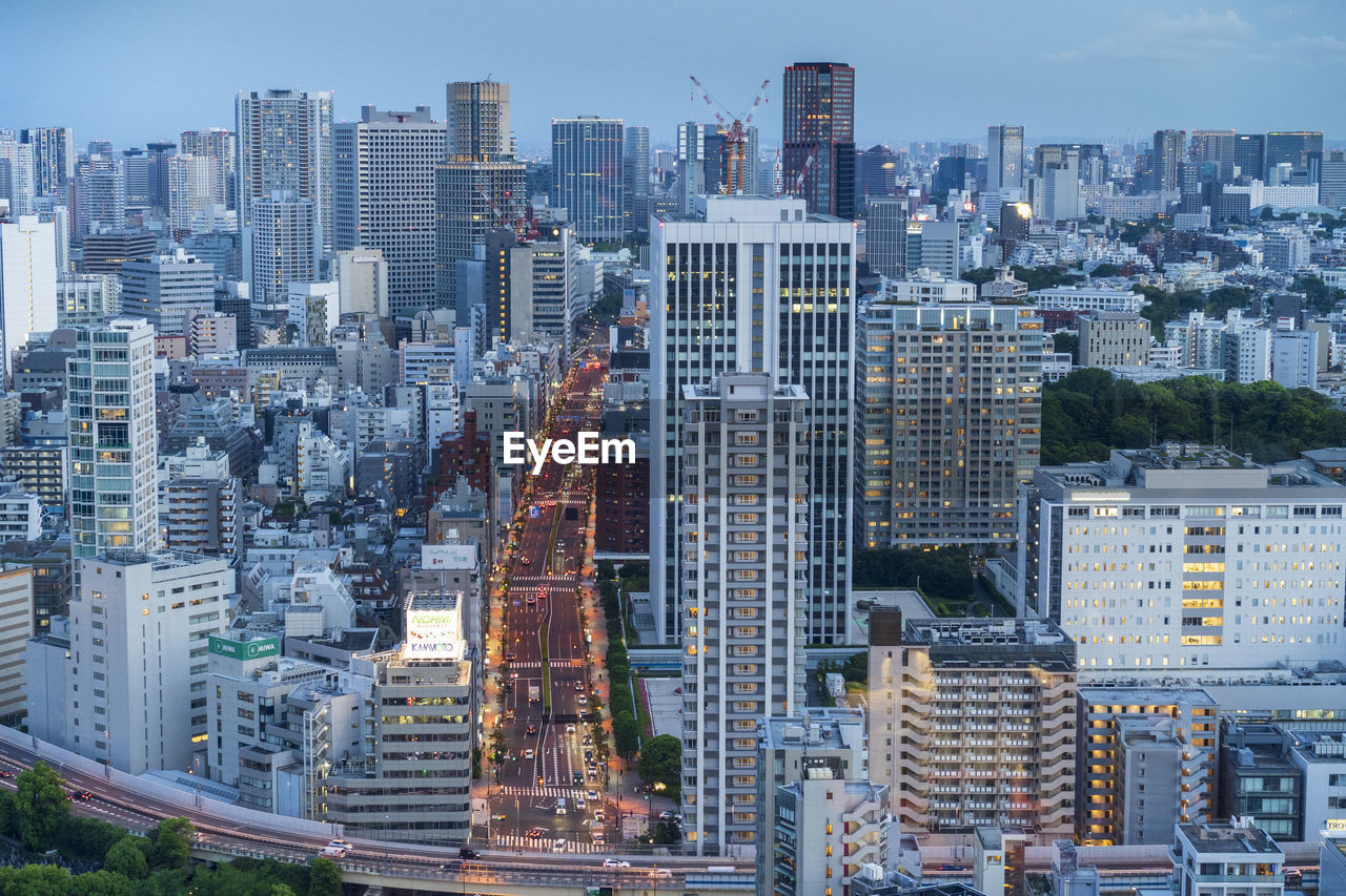 Aerial view of tokyo modern buildings in city against sky