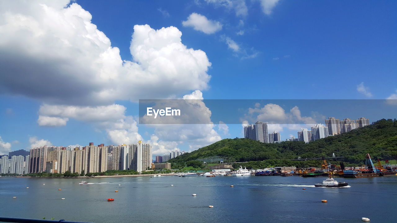 Panoramic view of city against cloudy sky