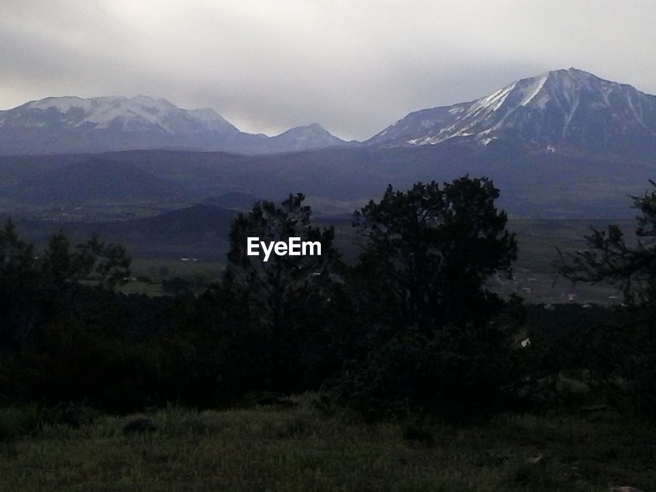 Countryside landscape against mountain range