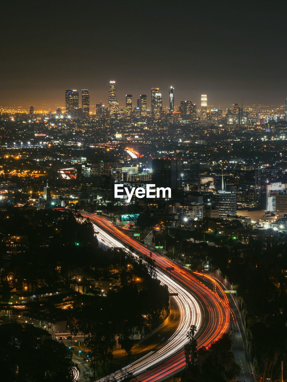 Illuminated cityscape against sky at night