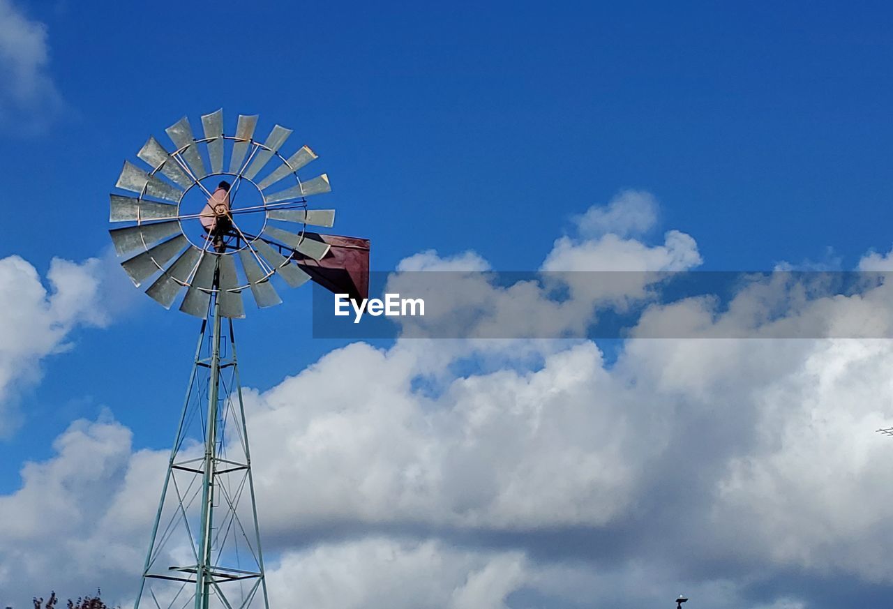 LOW ANGLE VIEW OF WINDMILL AGAINST BLUE SKY