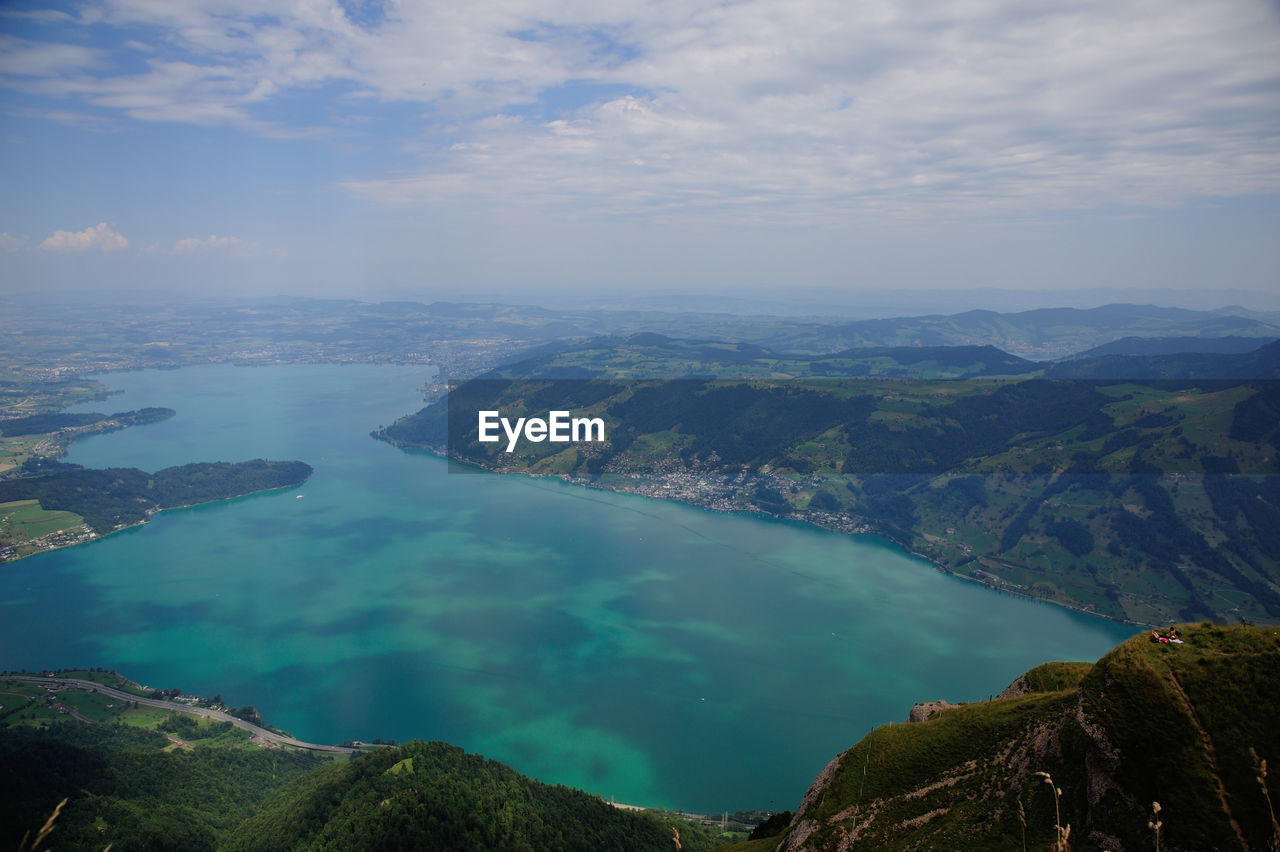 Scenic view of lake and mountains against sky