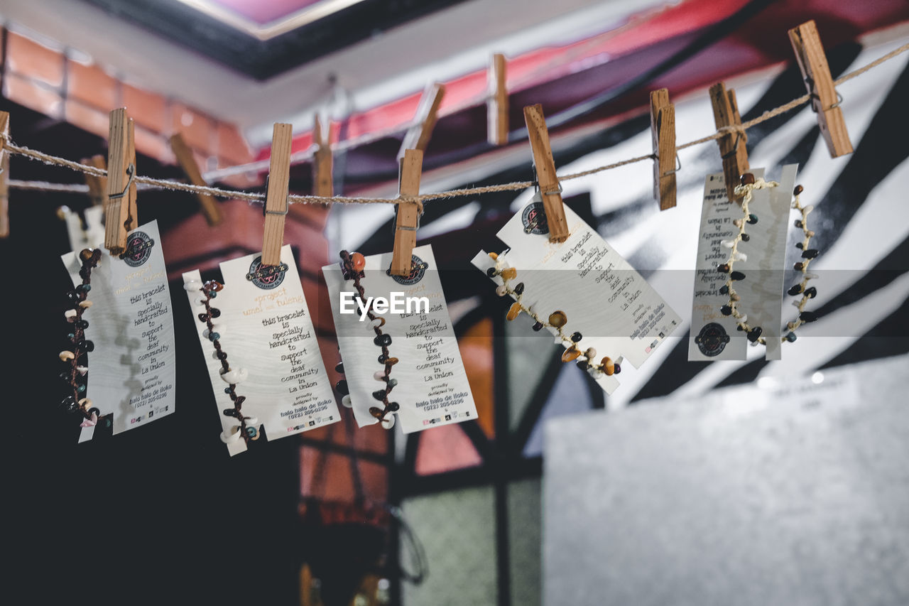 CLOSE-UP OF CLOTHES HANGING ON METAL