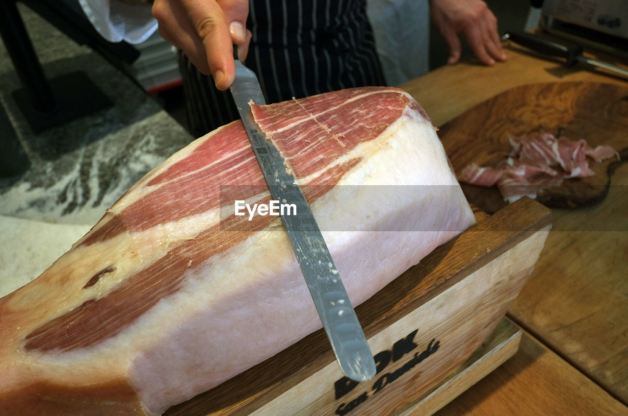 Cutting bacon with knife