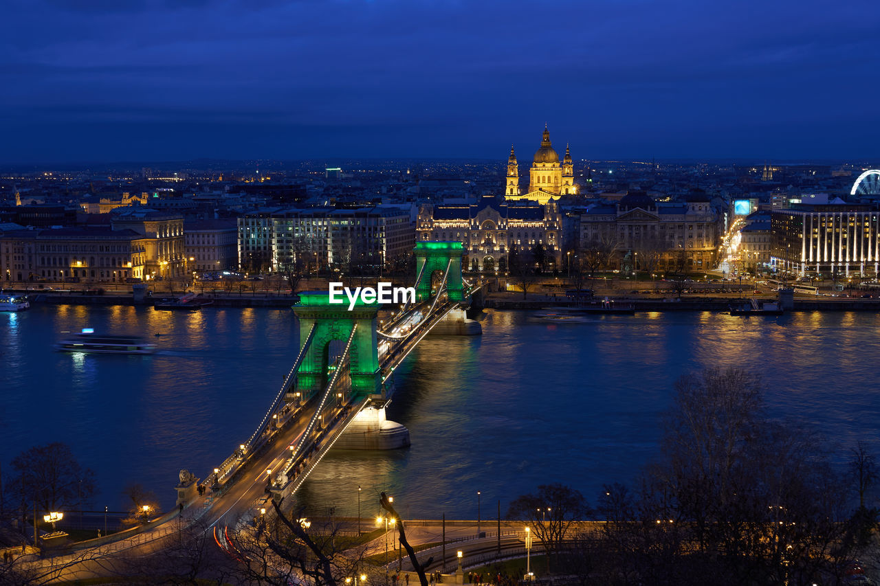 Budapest nighttime cityscape with chain bridge illuminated in green