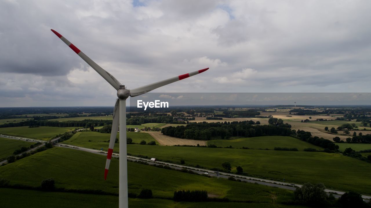 Windmill on field against sky