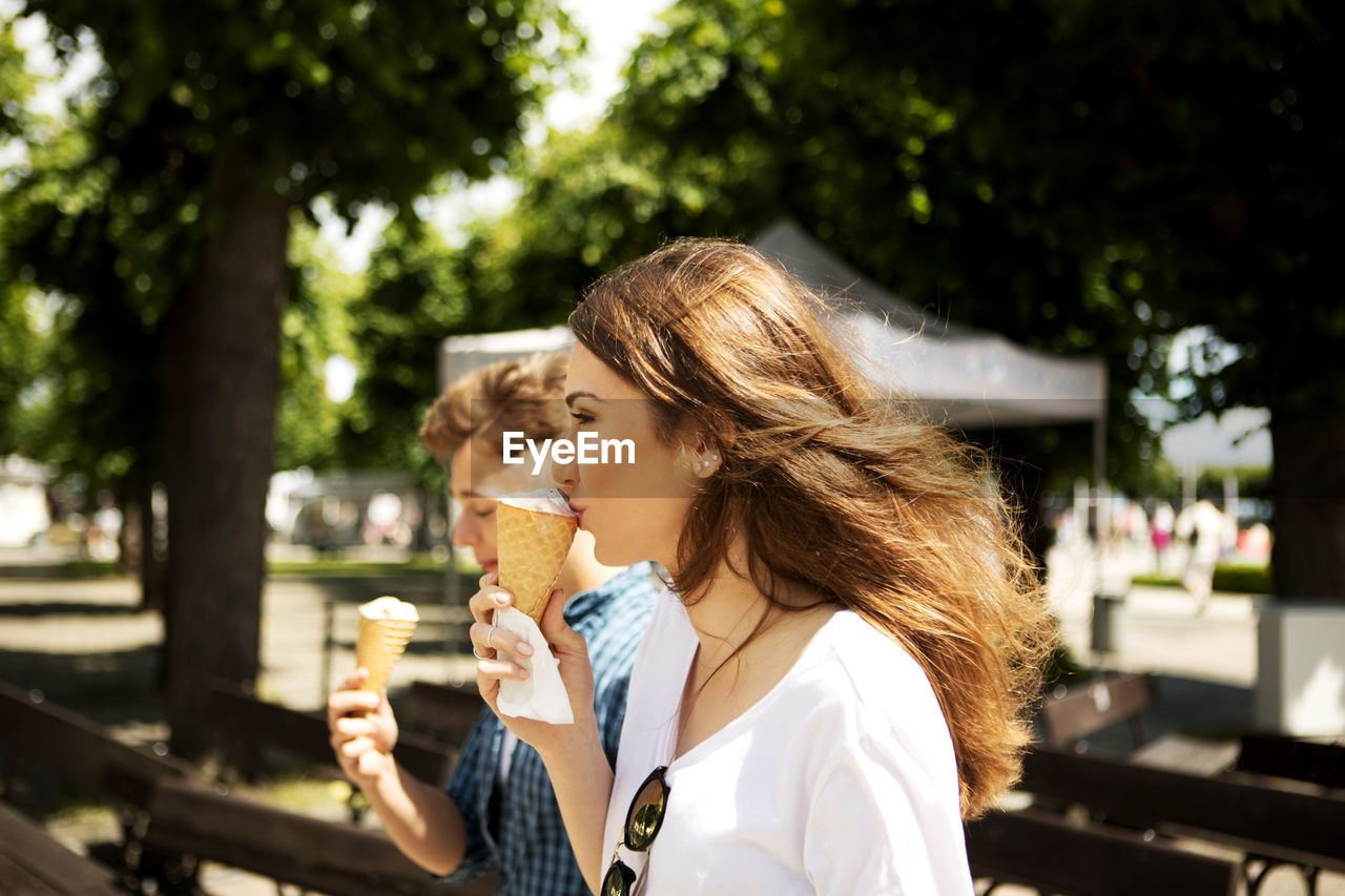 Friends eating ice cream in city
