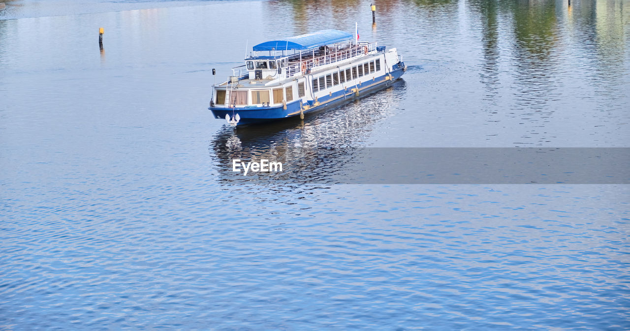 water, nautical vessel, transportation, reflection, mode of transportation, ship, vehicle, boat, channel, nature, day, lake, waterfront, waterway, watercraft, rippled, travel, no people, outdoors, ferry, moored, tranquility, body of water