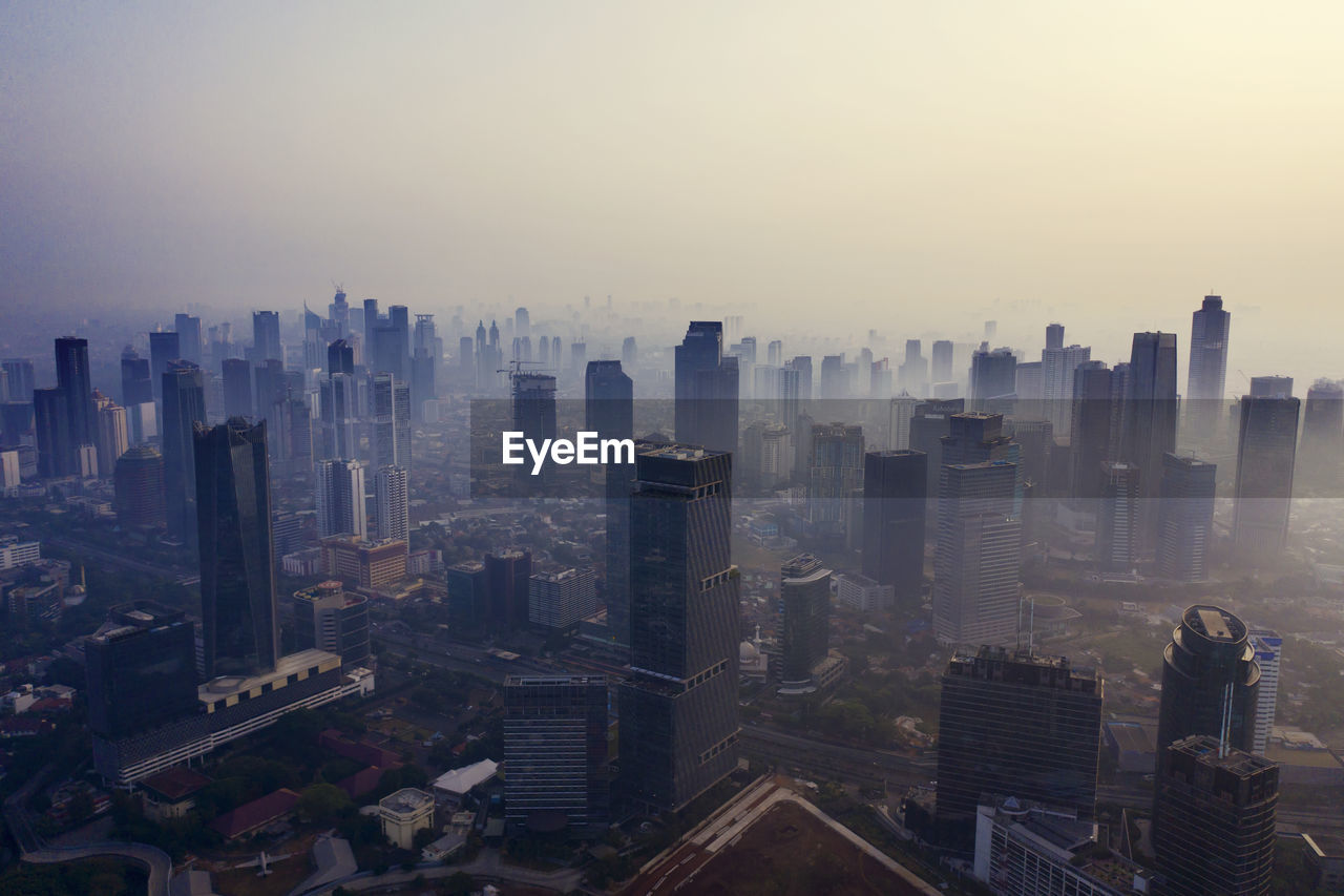 High angle view of buildings in city against sky