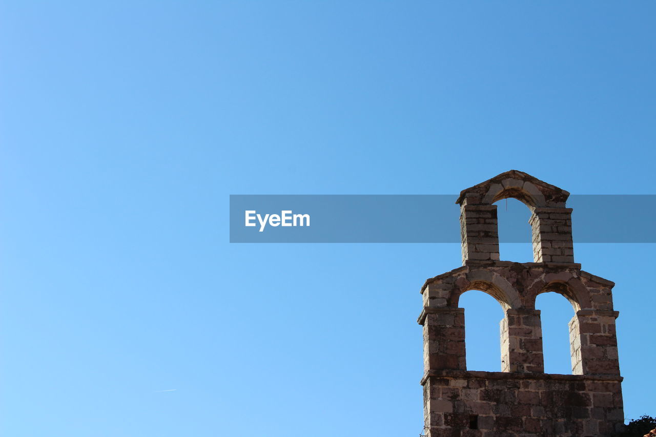 LOW ANGLE VIEW OF CHURCH AGAINST CLEAR BLUE SKY