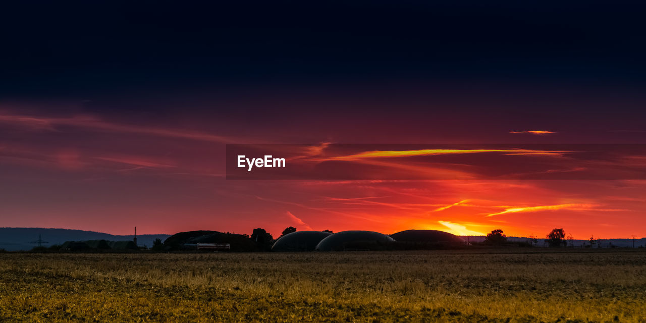 Scenic view of field against sky during sunset