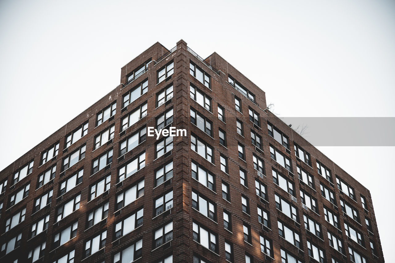 Low angle view of modern building against clear sky in manhattan