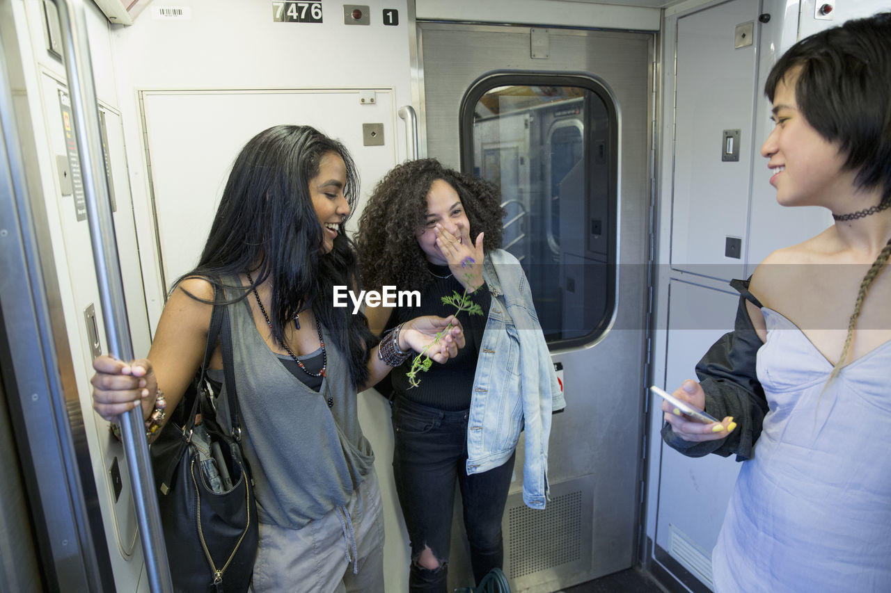 Friends commuting by train in queens, new york