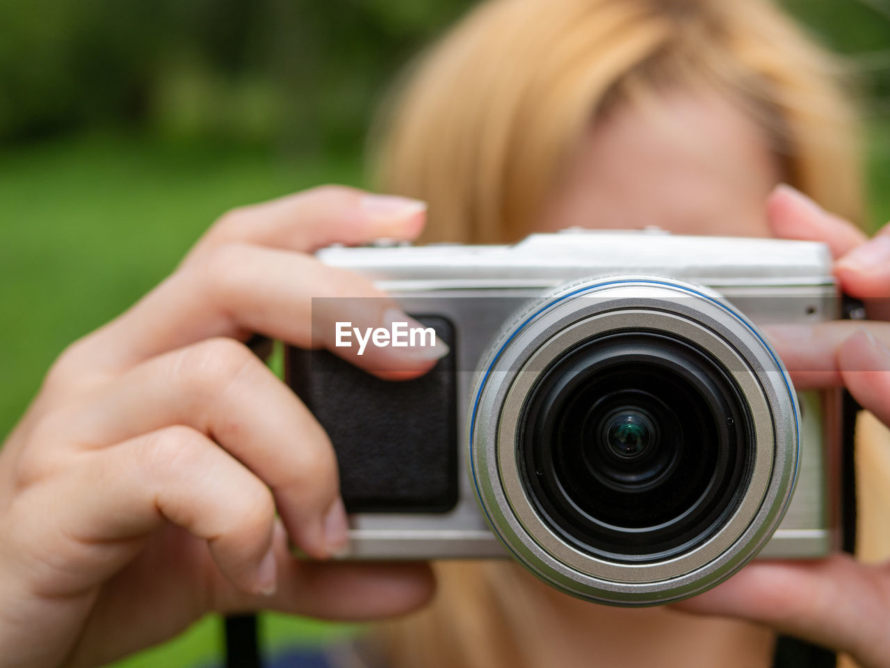 CROPPED IMAGE OF WOMAN PHOTOGRAPHING CAMERA