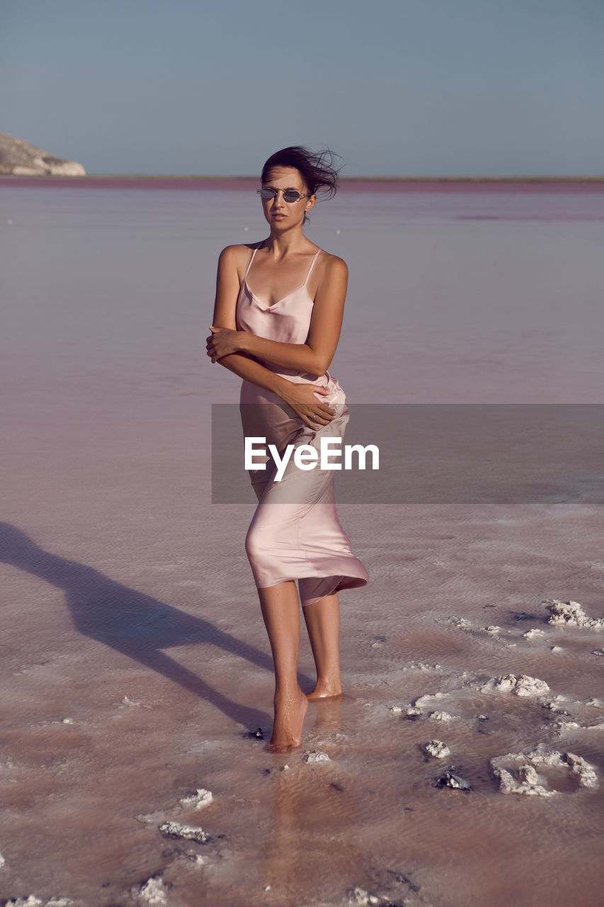 Woman on a dried up salt lake in a pink dress in the crimea