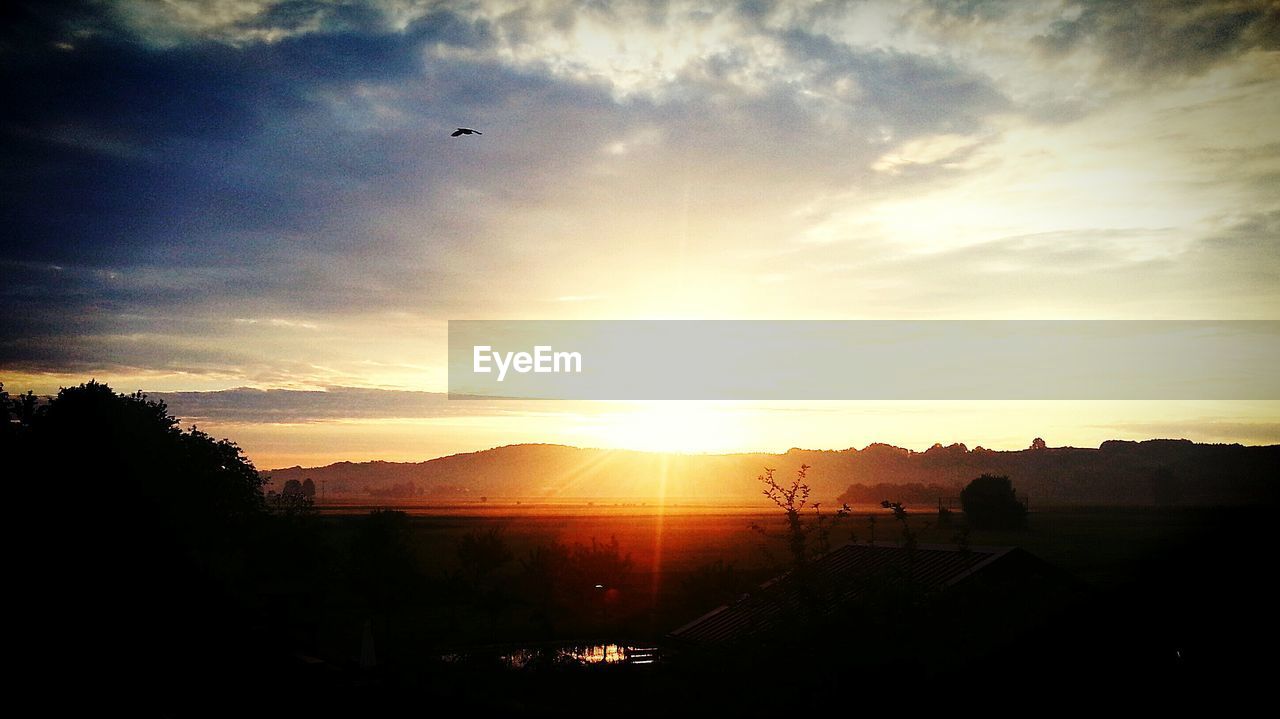 SILHOUETTE OF MOUNTAIN AT SUNSET