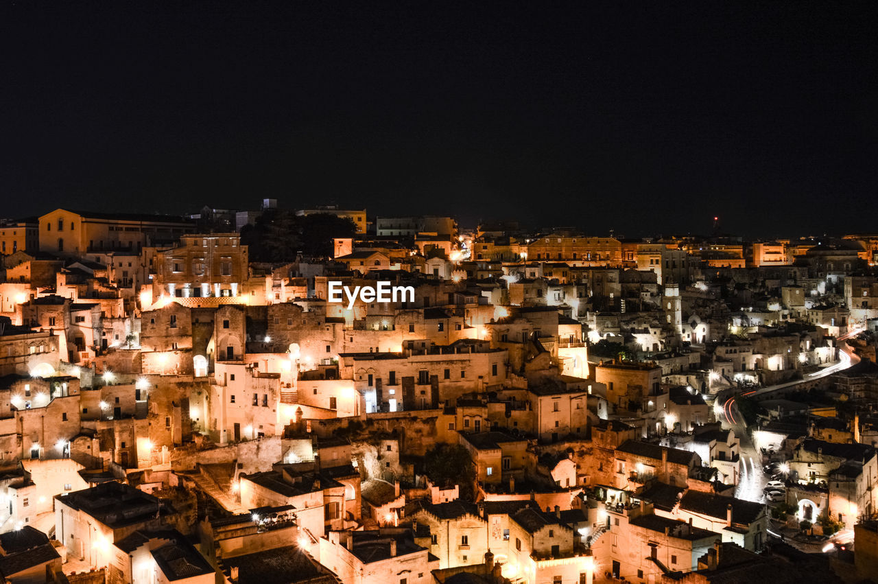 High angle shot of illuminated cityscape against clear sky