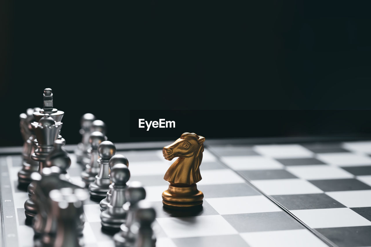 CLOSE-UP OF CHESS PIECES ON TABLE