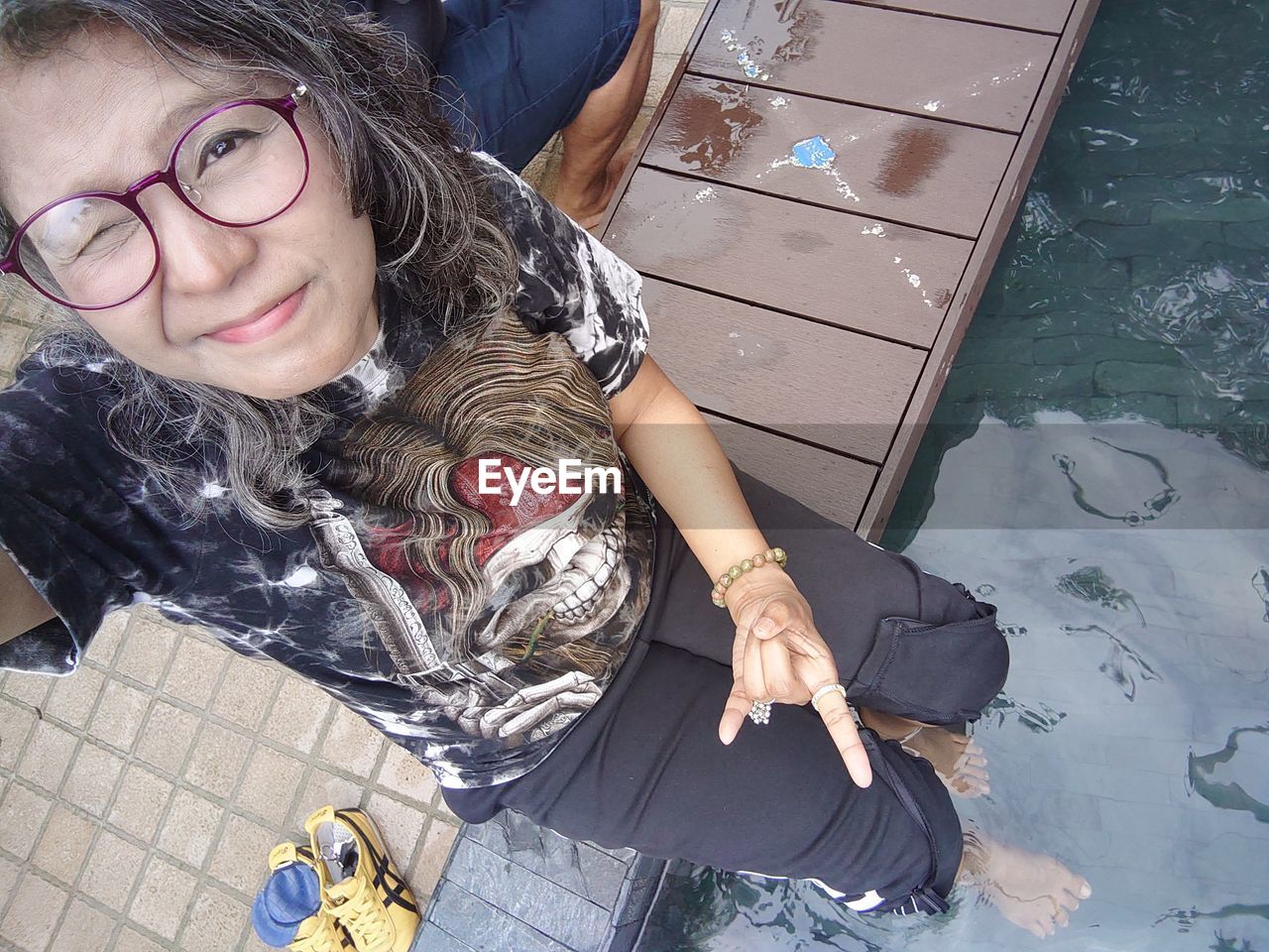 glasses, eyeglasses, one person, women, high angle view, portrait, adult, looking at camera, clothing, person, young adult, leisure activity, casual clothing, female, child, lifestyles, blue, human hair, smiling, photo shoot, sitting, hairstyle, human face, human leg, vision care, front view, flooring, footwear, full length, childhood