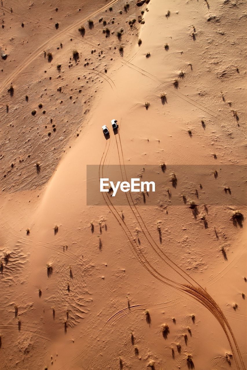 Aerial view of cars driving through desert