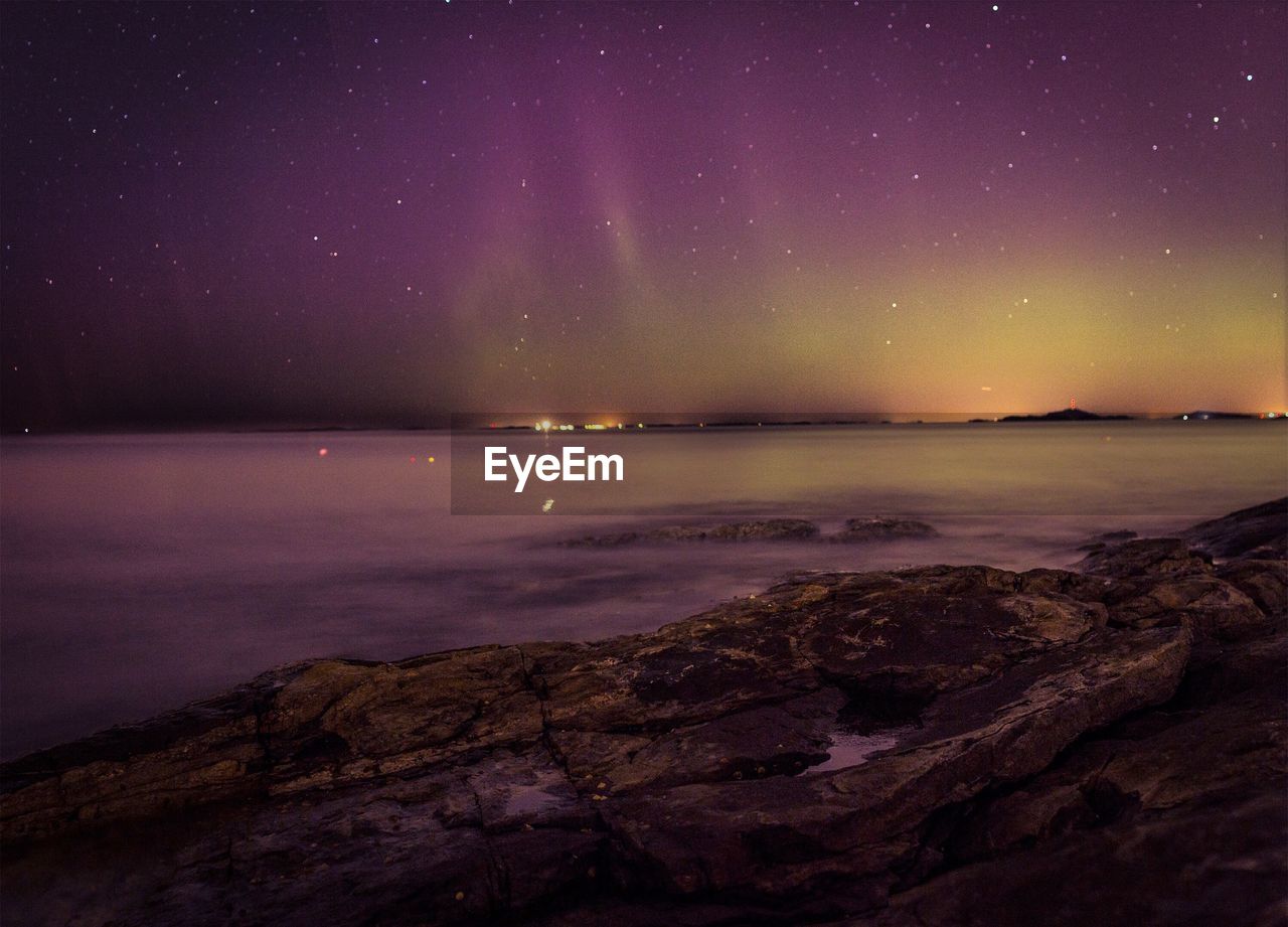 Scenic view of sea against sky at night