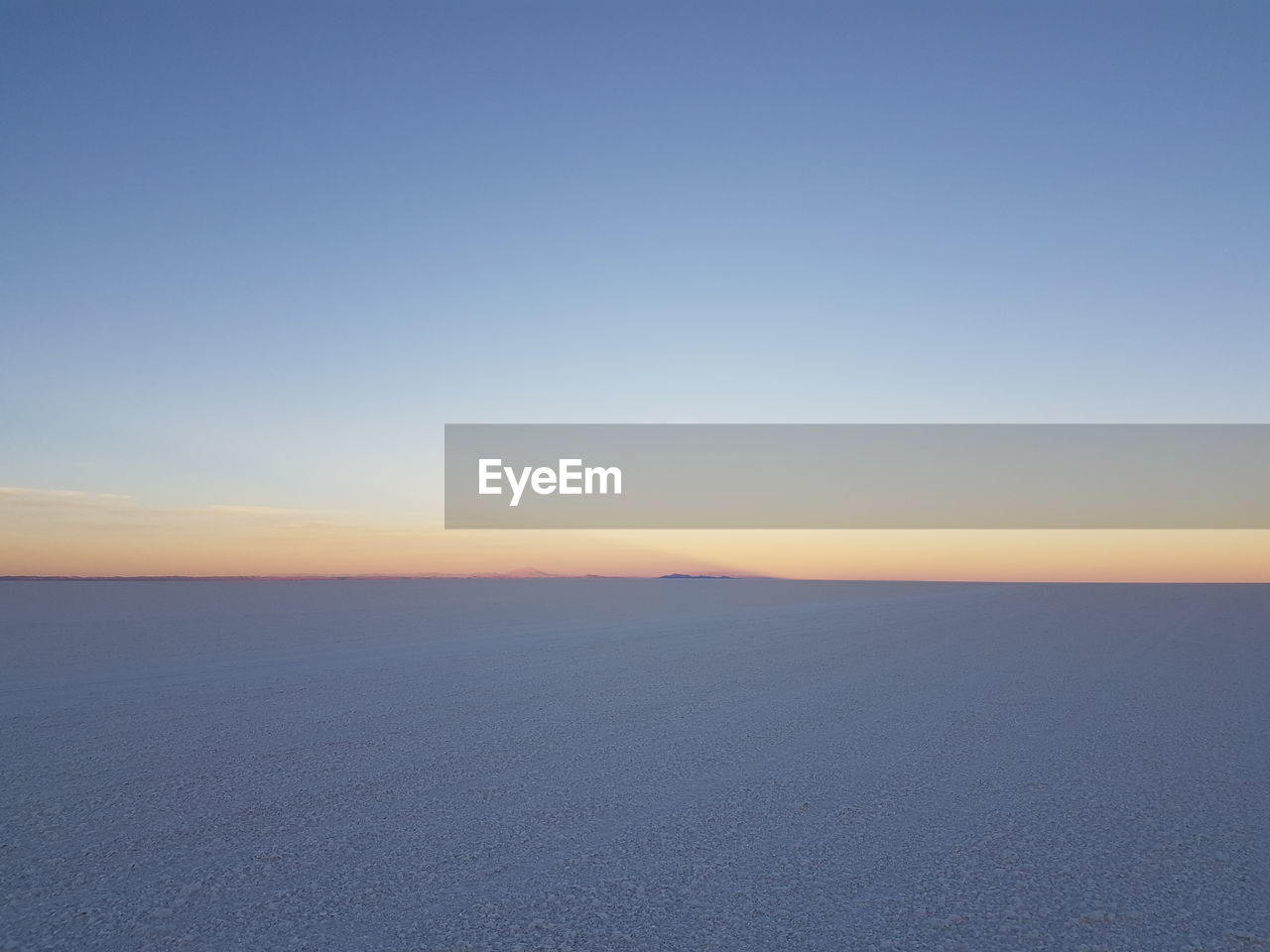 Scenic view of landscape against clear blue sky