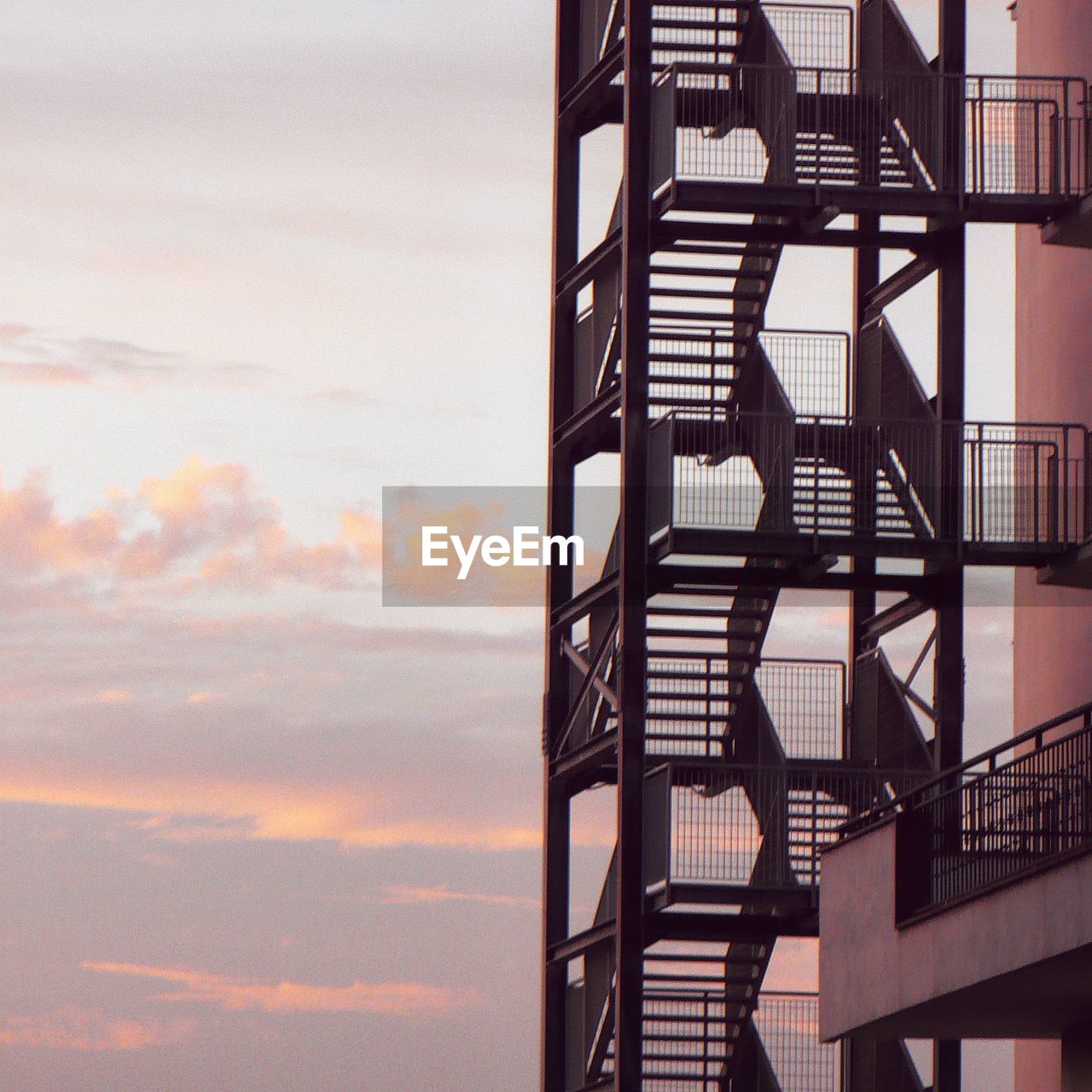 LOW ANGLE VIEW OF SPIRAL STAIRS AGAINST SKY