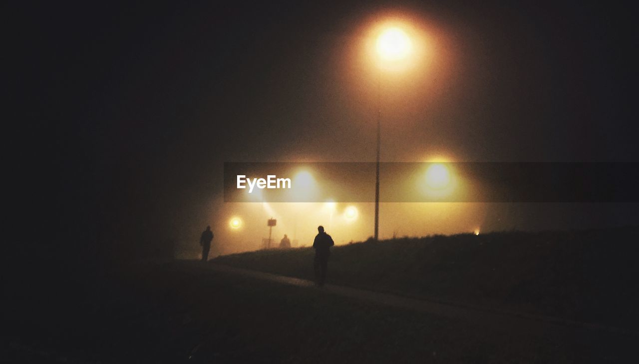 SILHOUETTE PEOPLE AT NIGHT