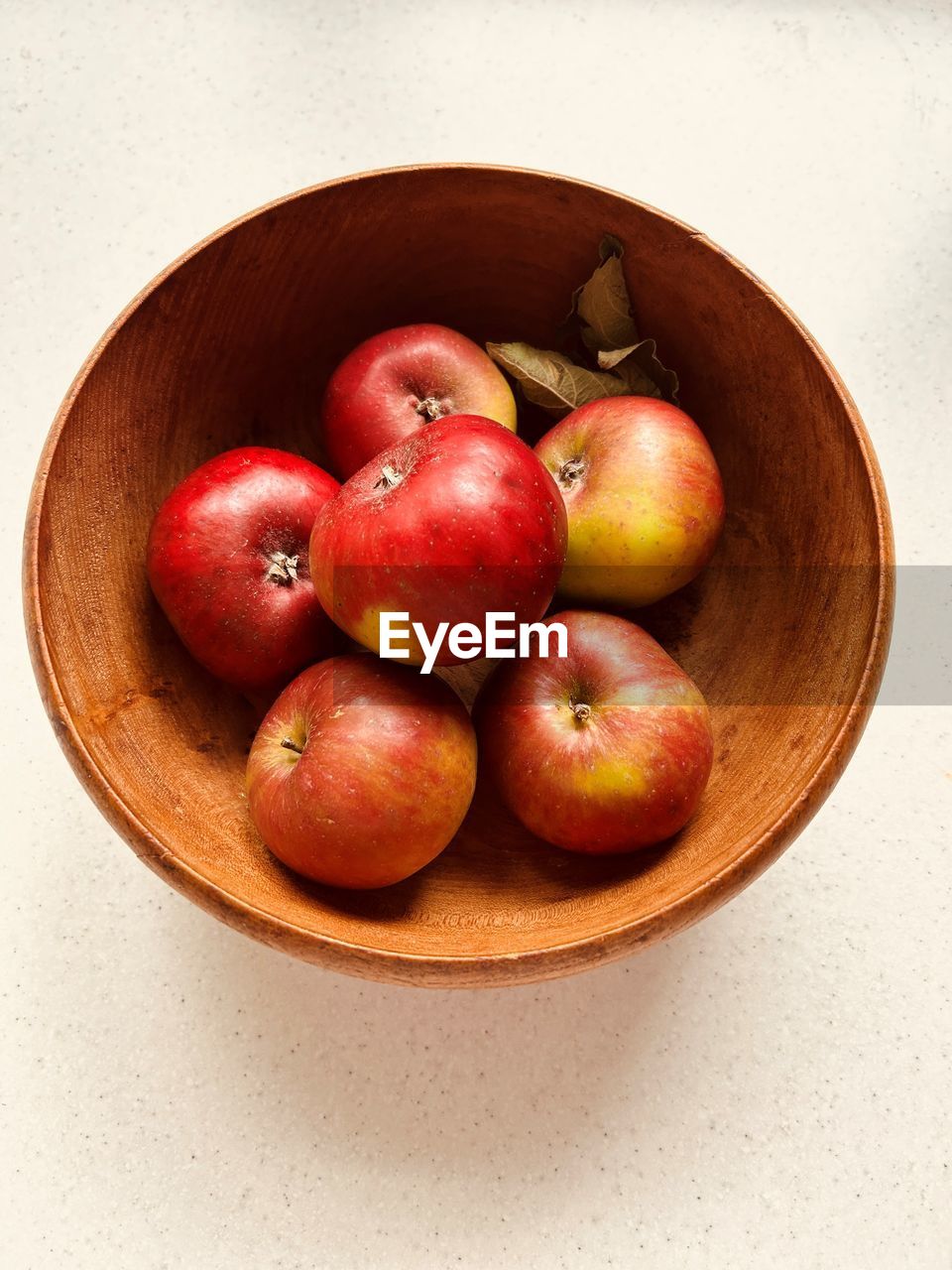 Six apples in wooden bowl. red and green apples. foraged in community orchard. fresh and juicy.