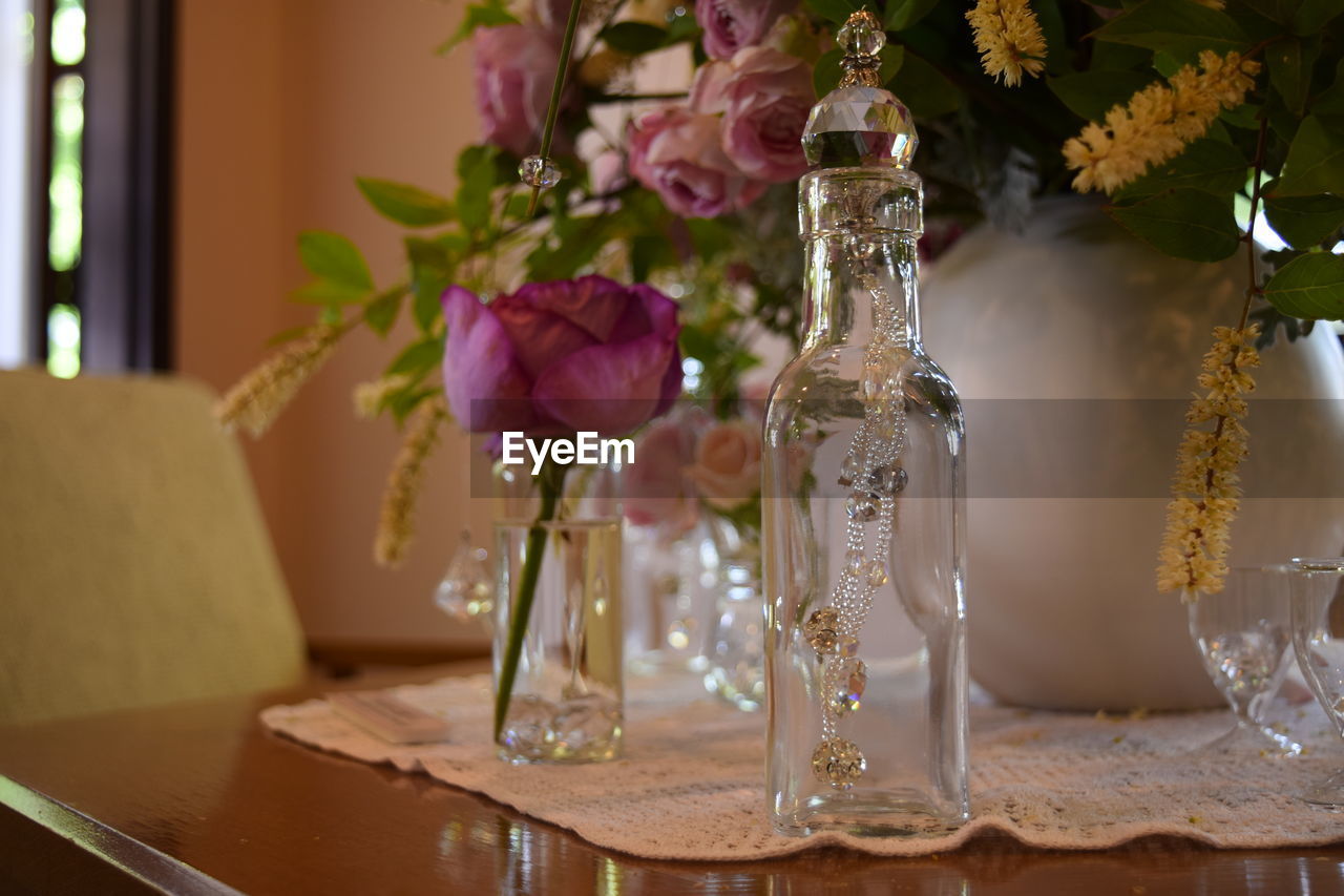 CLOSE-UP OF FLOWERS IN VASE ON TABLE