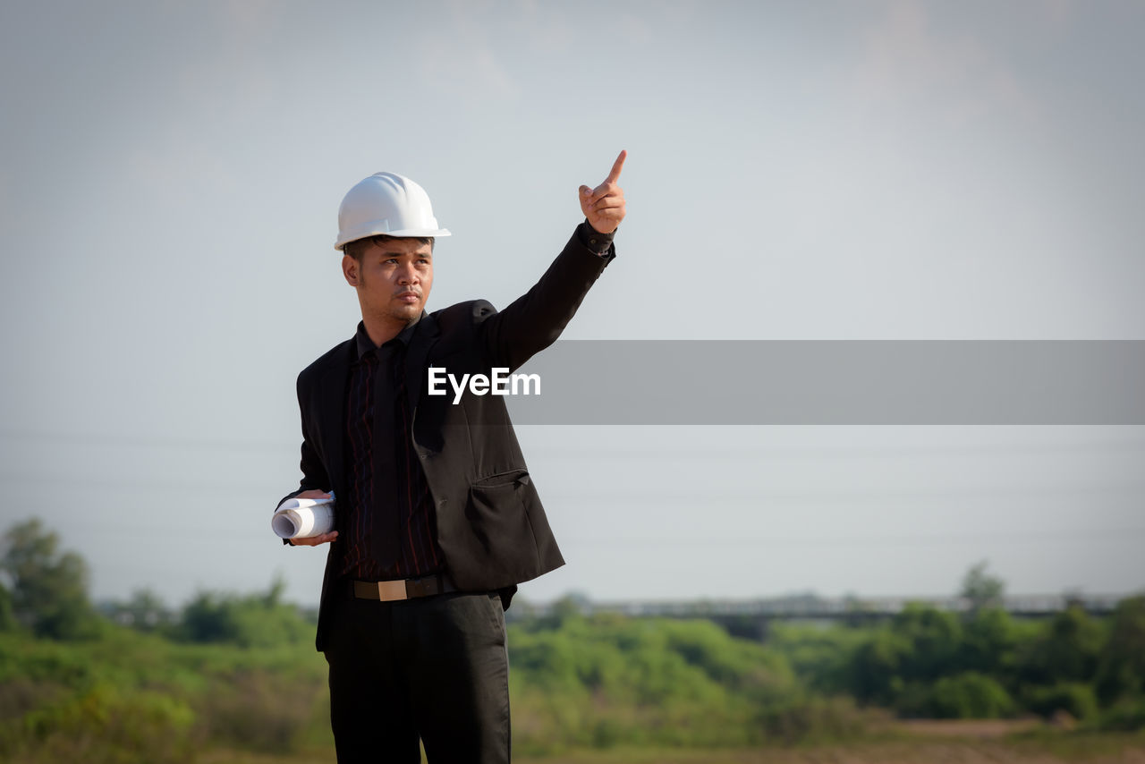 FULL LENGTH OF MAN STANDING IN FIELD