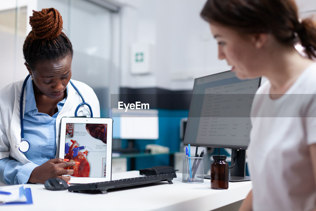 side view of doctor working on table