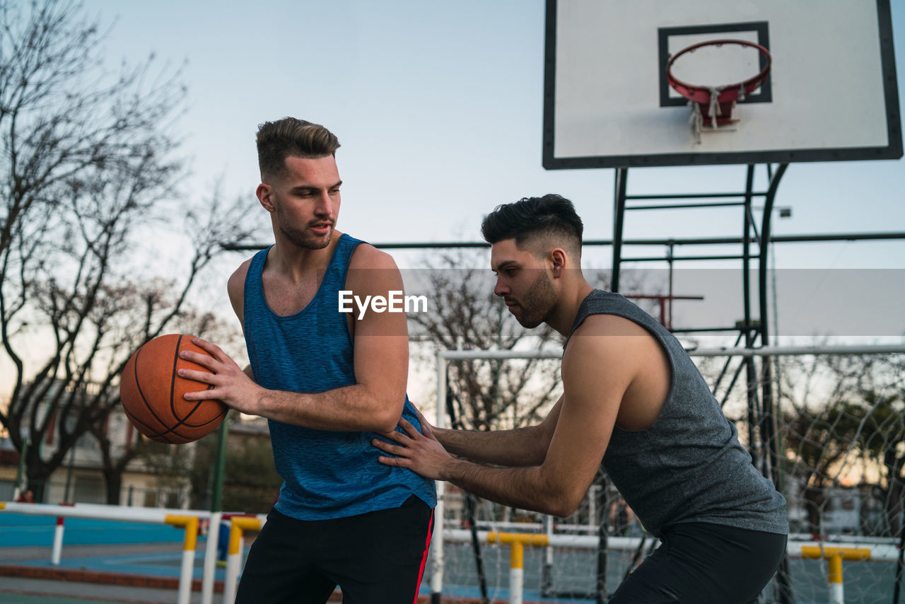 Young man playing with basketball