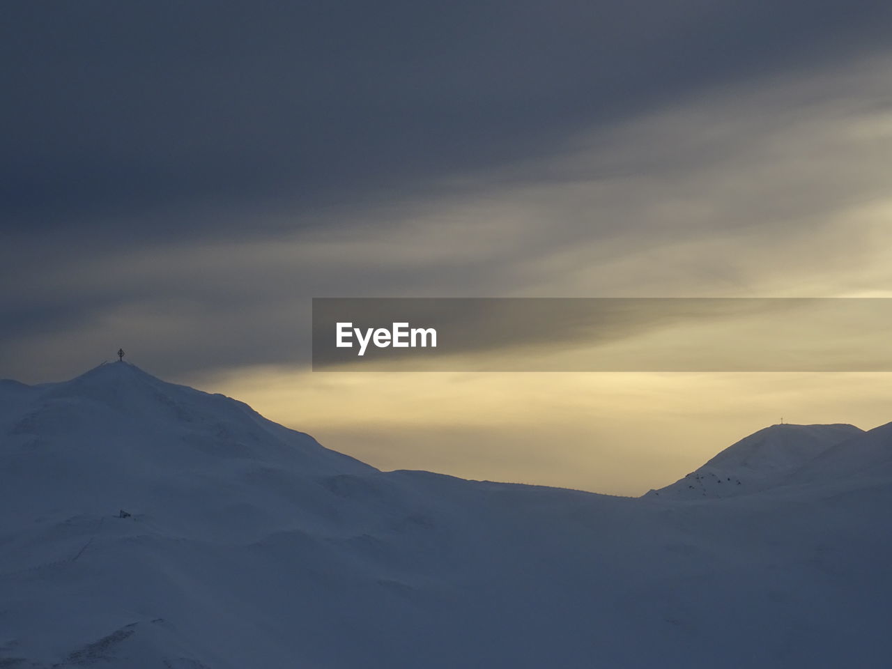 SNOWCAPPED MOUNTAINS AGAINST SKY DURING SUNSET