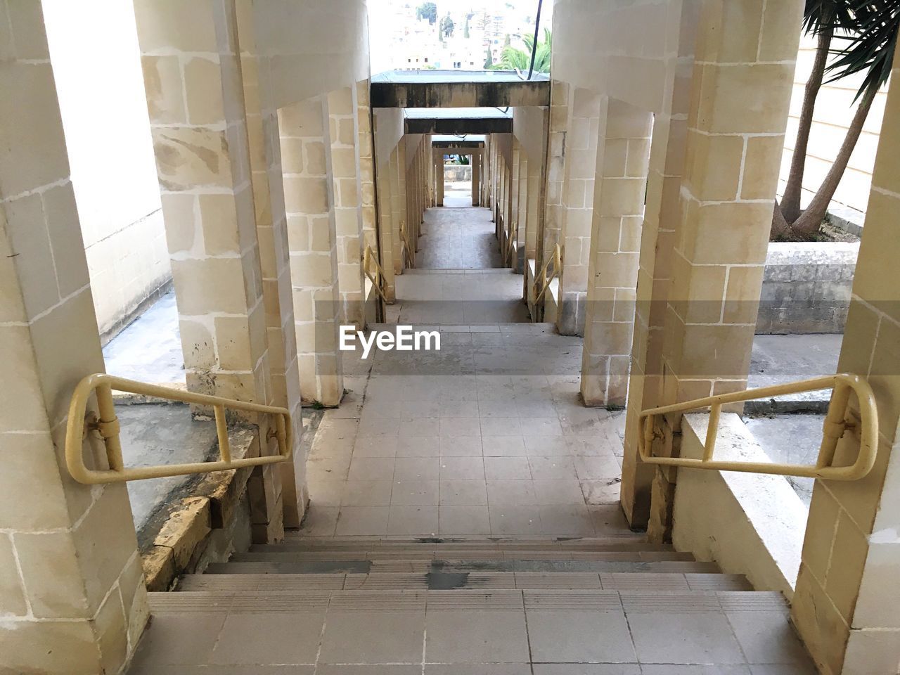 NARROW CORRIDOR ALONG PILLARS IN ROOM