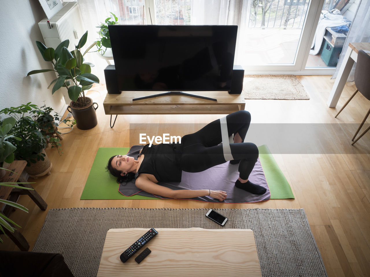 High angle view of woman exercising at home